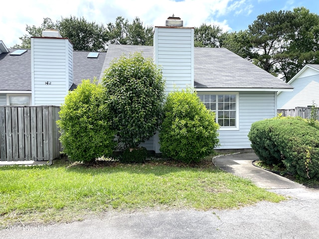 142 Witten Cir Unit A, Havelock, NC 28532 - view of side of home featuring a chimney and a shingled roof
