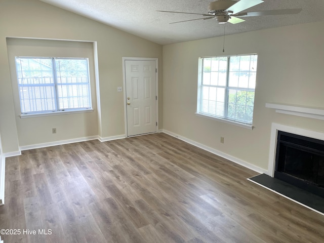 142 Witten Cir Unit A, Havelock, NC 28532 - unfurnished living room with ceiling fan, healthy amount of natural light, lofted ceiling, wood finished floors, and a textured ceiling