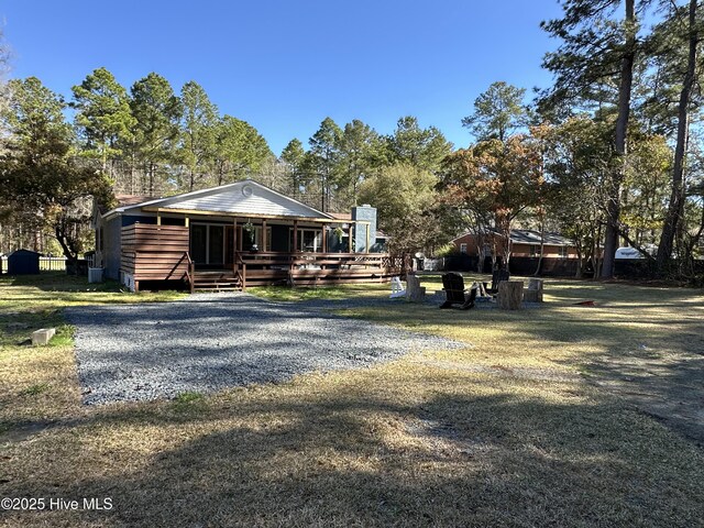 13280 Blues Farm Rd, Laurinburg, NC 28352 - rear view of house featuring a chimney, a deck, and a yard