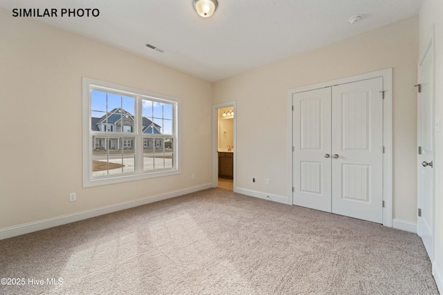 284 Water Wagon Trl, Jacksonville, NC 28546 - unfurnished bedroom with baseboards, carpet, a closet, and visible vents