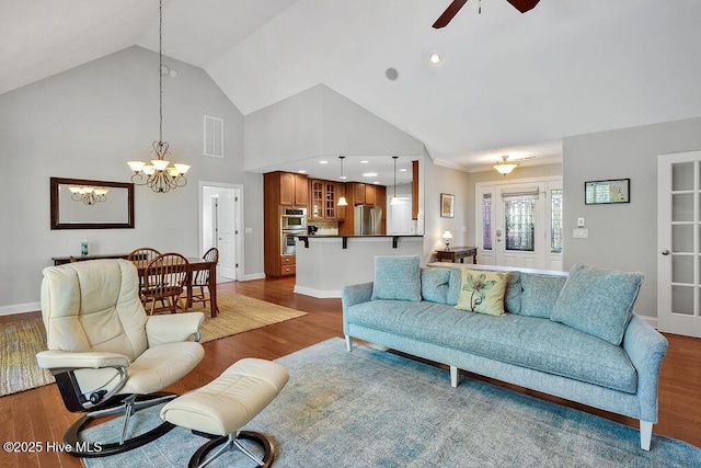 1061 Leesburg Dr, Leland, NC 28451 - living area featuring baseboards, visible vents, ceiling fan with notable chandelier, wood finished floors, and high vaulted ceiling