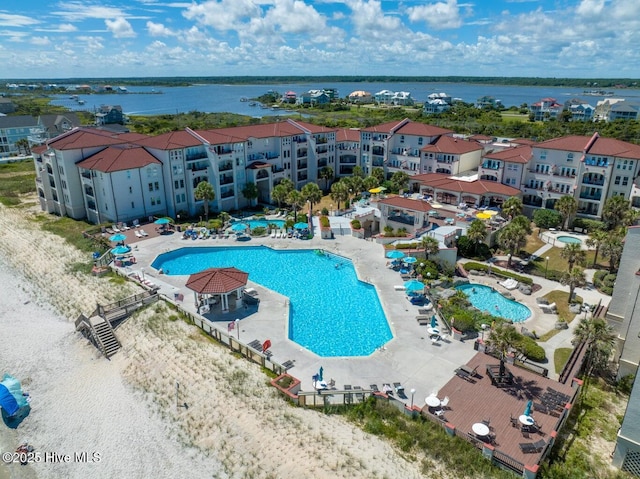 community pool featuring a patio and a water view