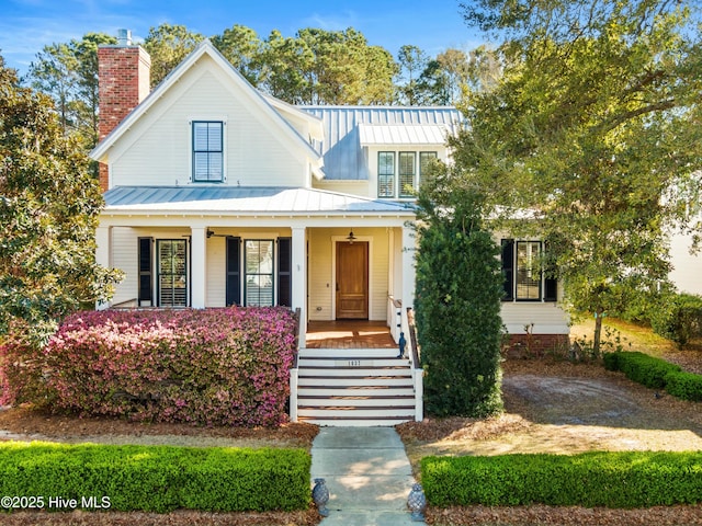 1037 Anchors Bend Way, Wilmington, NC 28411 - view of front of house featuring covered porch, a standing seam roof, a chimney, and stairs