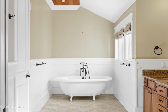 1037 Anchors Bend Way, Wilmington, NC 28411 - bathroom with tile patterned flooring, vanity, wainscoting, a freestanding tub, and vaulted ceiling