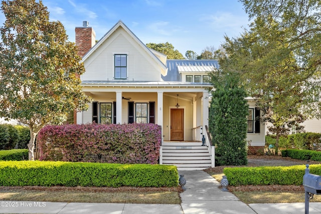 1037 Anchors Bend Way, Wilmington, NC 28411 - view of front of home with covered porch, ceiling fan, a standing seam roof, a chimney, and metal roof