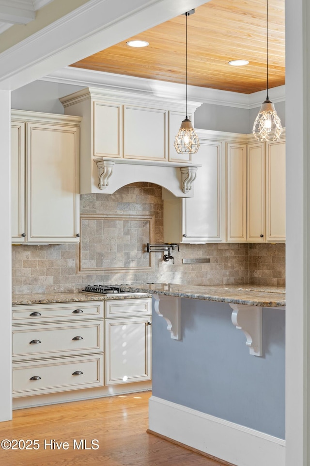 1037 Anchors Bend Way, Wilmington, NC 28411 - kitchen with crown molding, a kitchen breakfast bar, decorative light fixtures, and light stone counters