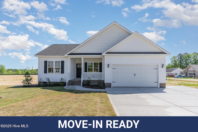 30 Tee Dr, Selma, NC 27576 - view of front of property featuring driveway, covered porch, an attached garage, a shingled roof, and a front yard