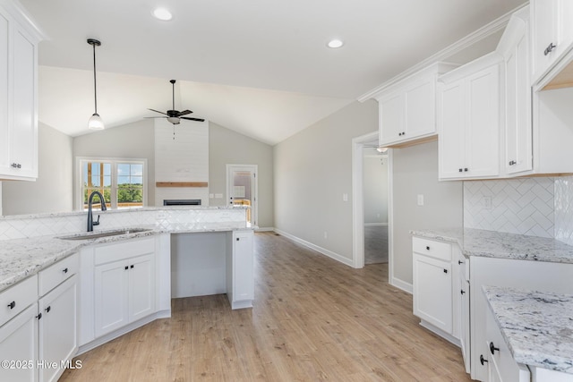 30 Tee Dr, Selma, NC 27576 - kitchen featuring white cabinets, light wood-style flooring, a sink, decorative backsplash, and a ceiling fan