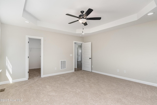 30 Tee Dr, Selma, NC 27576 - unfurnished bedroom featuring light carpet, visible vents, recessed lighting, and a raised ceiling