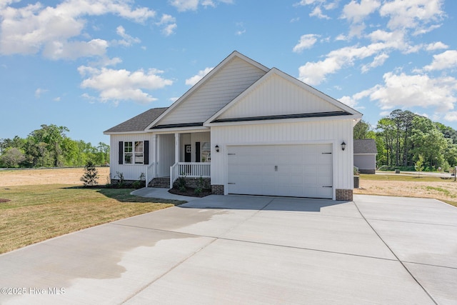 30 Tee Dr, Selma, NC 27576 - view of front of house featuring a front lawn, driveway, covered porch, an attached garage, and a shingled roof