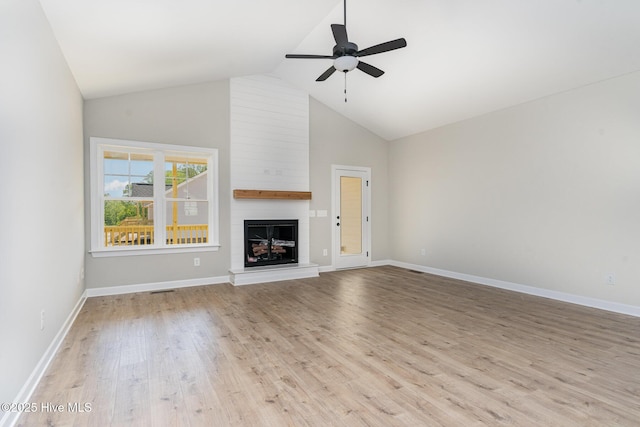 30 Tee Dr, Selma, NC 27576 - unfurnished living room featuring baseboards, light wood-style floors, high vaulted ceiling, ceiling fan, and a fireplace