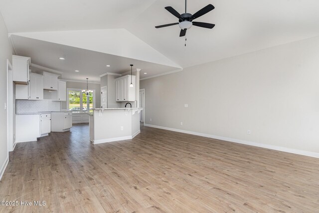 30 Tee Dr, Selma, NC 27576 - unfurnished living room with recessed lighting, lofted ceiling, baseboards, light wood-style flooring, and ceiling fan