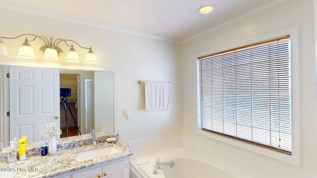 bathroom with a bath, a textured ceiling, vanity, and crown molding
