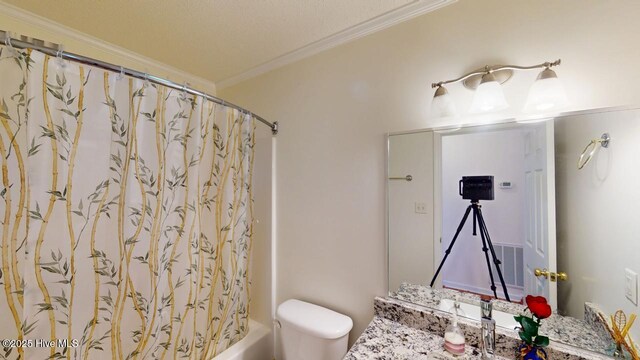 full bath featuring visible vents, crown molding, toilet, shower / tub combo, and vanity