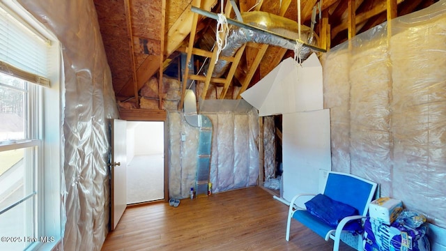 misc room featuring vaulted ceiling and wood finished floors