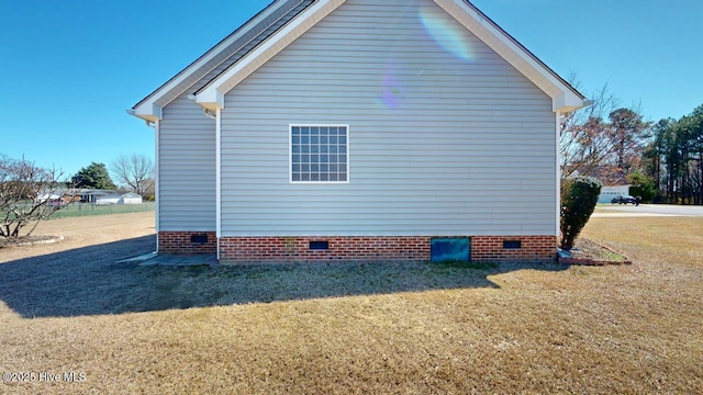view of property exterior featuring a lawn and crawl space
