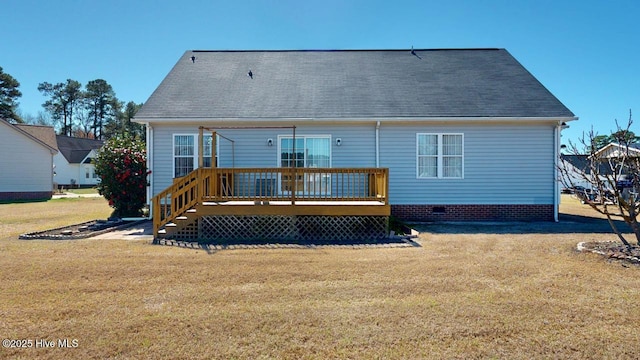 rear view of house with a wooden deck and a yard