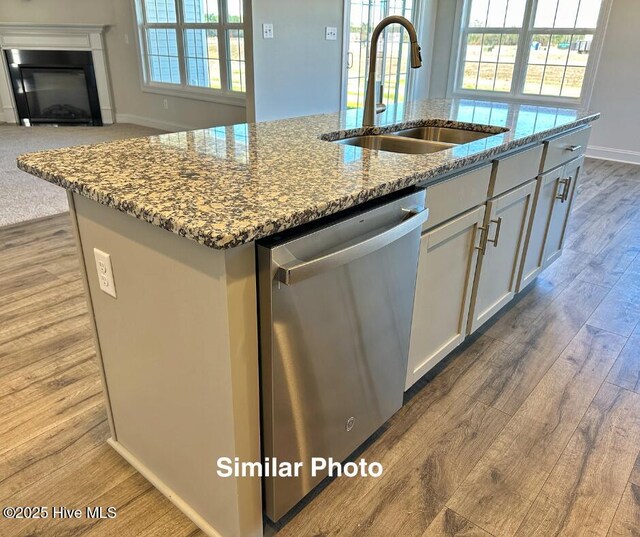 745 Secession Ln, Jacksonville, NC 28546 - kitchen with an island with sink, a sink, light stone countertops, wood finished floors, and stainless steel dishwasher