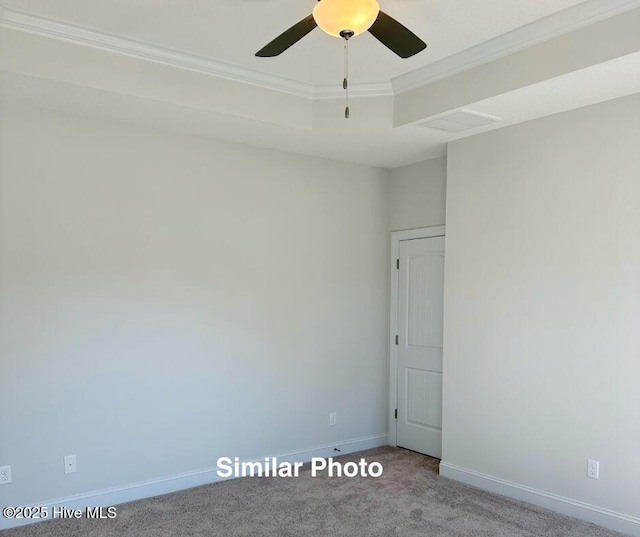 745 Secession Ln, Jacksonville, NC 28546 - carpeted empty room with visible vents, crown molding, baseboards, a ceiling fan, and a tray ceiling