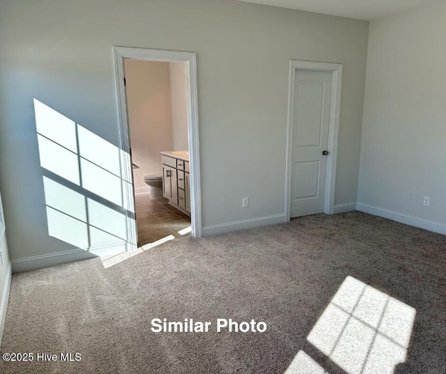 745 Secession Ln, Jacksonville, NC 28546 - unfurnished bedroom featuring carpet floors, ensuite bathroom, and baseboards