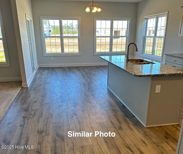 745 Secession Ln, Jacksonville, NC 28546 - kitchen with an inviting chandelier, dark wood-style flooring, a sink, and stone countertops