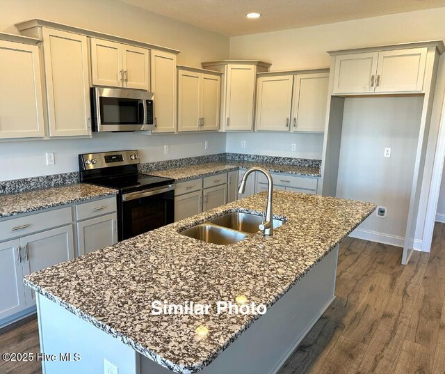 745 Secession Ln, Jacksonville, NC 28546 - kitchen featuring dark stone counters, a sink, stainless steel appliances, and dark wood-style floors