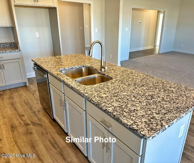 745 Secession Ln, Jacksonville, NC 28546 - kitchen with light stone counters, a sink, wood finished floors, dishwasher, and a center island with sink