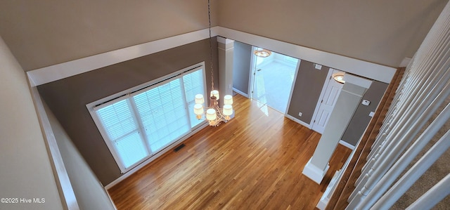 2429 Falls River Ave, Raleigh, NC 27614 - hall with wood finished floors and a chandelier