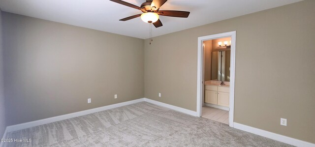 2429 Falls River Ave, Raleigh, NC 27614 - unfurnished bedroom featuring light colored carpet, ensuite bath, and ceiling fan