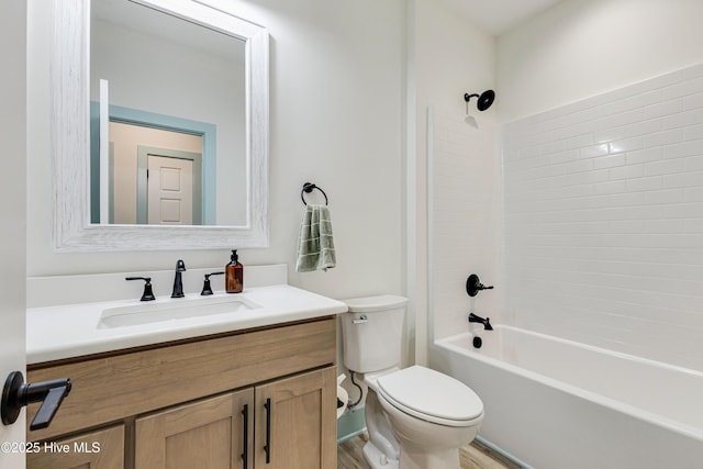 bathroom featuring vanity, bathtub / shower combination, and toilet