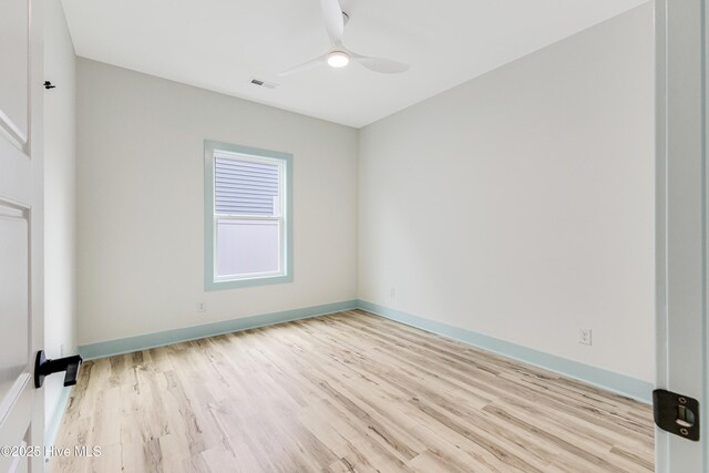 123 NW 12th St, Oak Island, NC 28465 - spare room featuring light wood-type flooring, a ceiling fan, and baseboards