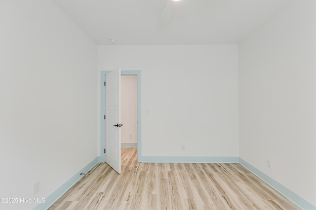 unfurnished room with wood finished floors and baseboards