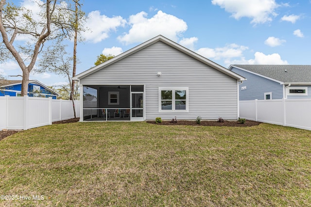 rear view of property with a yard, a fenced backyard, a sunroom, and a ceiling fan