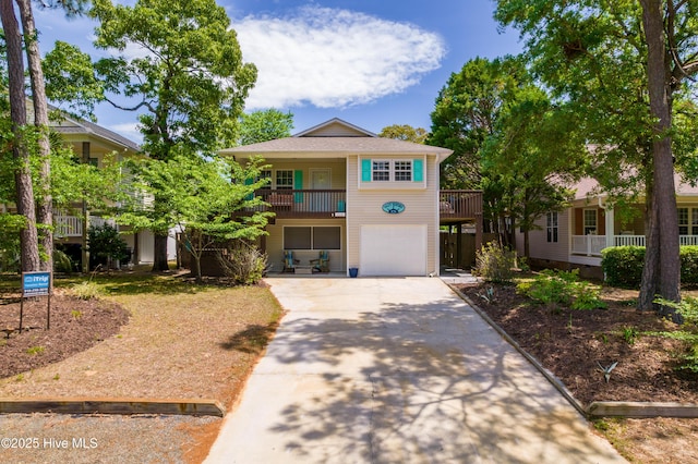 222 NE 36th St, Oak Island, NC 28465 - view of front of home with driveway, a balcony, and an attached garage