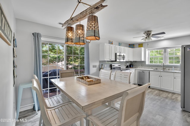 222 NE 36th St, Oak Island, NC 28465 - dining space featuring light wood-type flooring and ceiling fan
