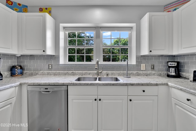 222 NE 36th St, Oak Island, NC 28465 - kitchen featuring a sink, decorative backsplash, white cabinetry, light countertops, and dishwasher