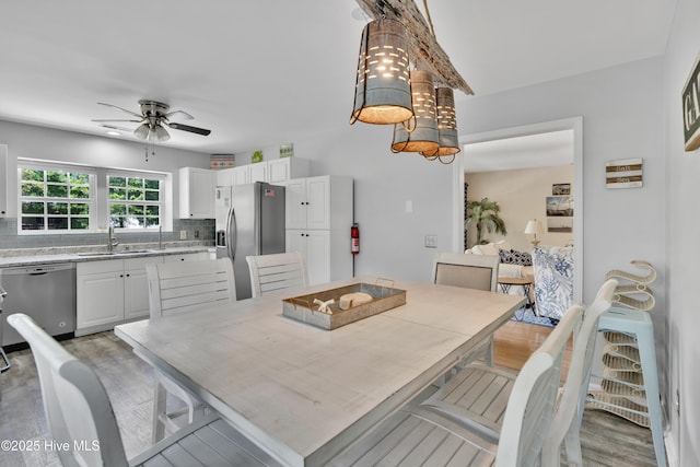 222 NE 36th St, Oak Island, NC 28465 - dining area with light wood-type flooring and ceiling fan