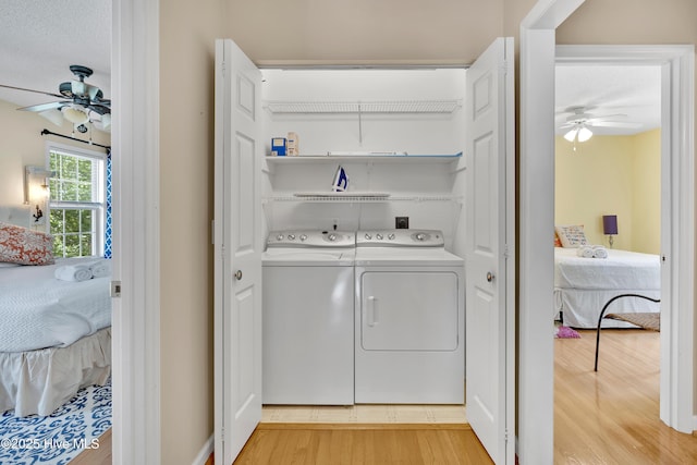 222 NE 36th St, Oak Island, NC 28465 - laundry room with a ceiling fan, separate washer and dryer, laundry area, and light wood finished floors