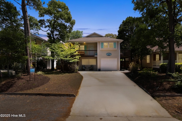 222 NE 36th St, Oak Island, NC 28465 - view of front of house with concrete driveway and a garage