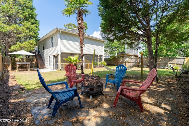 222 NE 36th St, Oak Island, NC 28465 - exterior space with an outdoor fire pit, a fenced backyard, and stairway