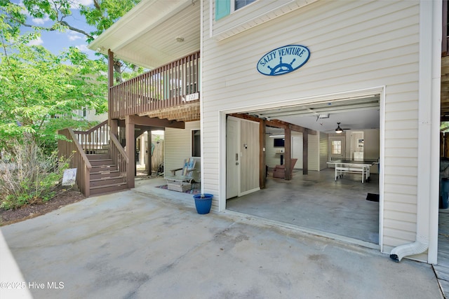 222 NE 36th St, Oak Island, NC 28465 - view of patio featuring stairs, a garage, and a wooden deck