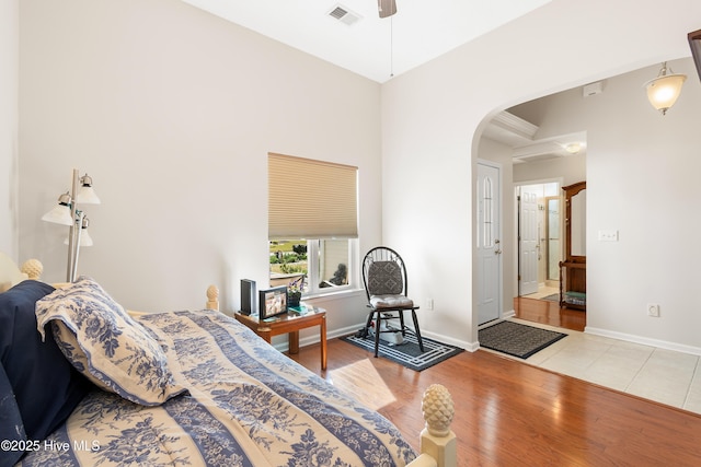 659 Meadowbrook Ln NW, Calabash, NC 28467 - bedroom featuring arched walkways, wood finished floors, baseboards, and a ceiling fan