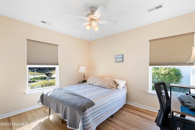 659 Meadowbrook Ln NW, Calabash, NC 28467 - bedroom featuring multiple windows, baseboards, and hardwood / wood-style flooring