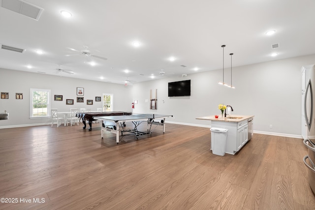659 Meadowbrook Ln NW, Calabash, NC 28467 - rec room with a sink, baseboards, wood finished floors, ceiling fan, and recessed lighting