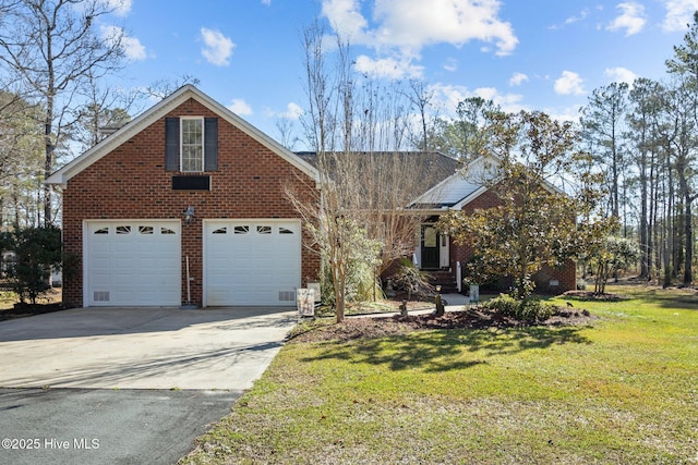view of front of house with a front lawn, a garage, brick siding, and driveway