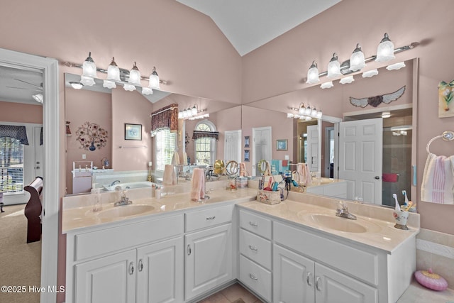 full bathroom featuring lofted ceiling, a wealth of natural light, and a sink