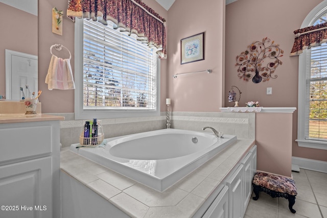 full bathroom featuring a bath, vanity, and tile patterned flooring