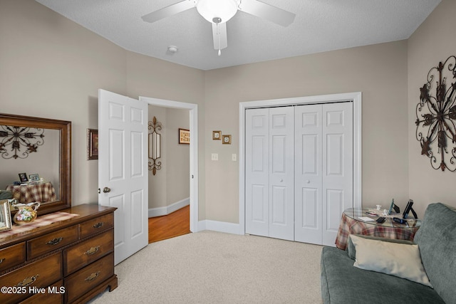 sitting room featuring light colored carpet, baseboards, and ceiling fan