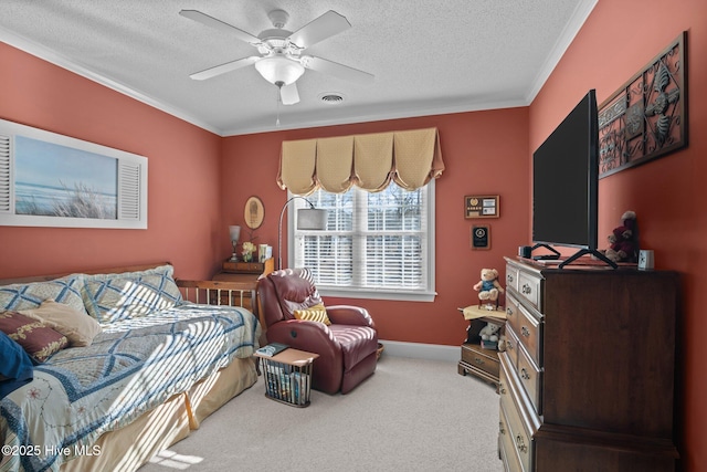 bedroom featuring a ceiling fan, carpet, visible vents, ornamental molding, and a textured ceiling