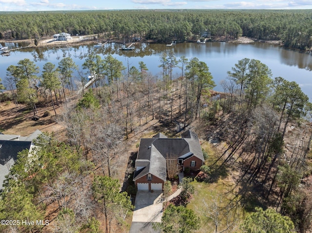 aerial view with a water view and a wooded view